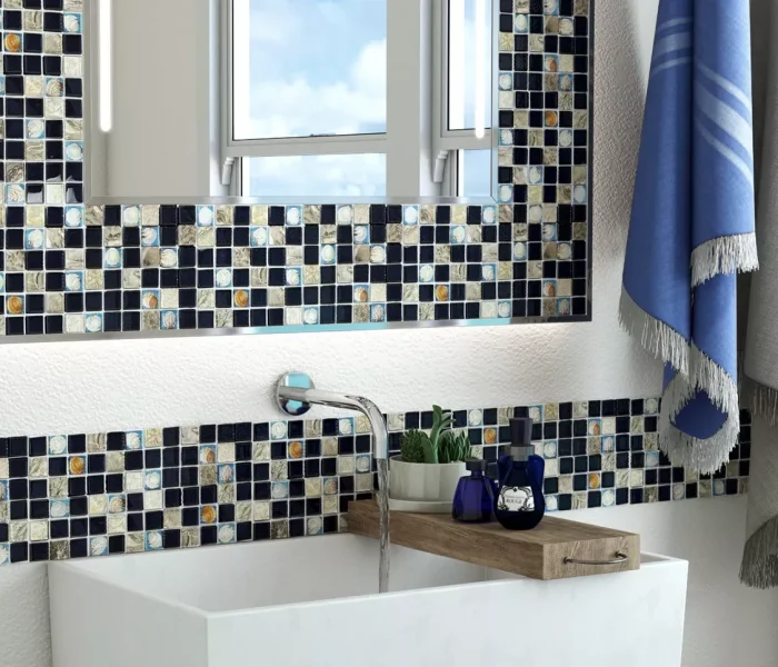 A bathroom featuring a lighted mirror with mosaic frame matching the wall in Brisbane.