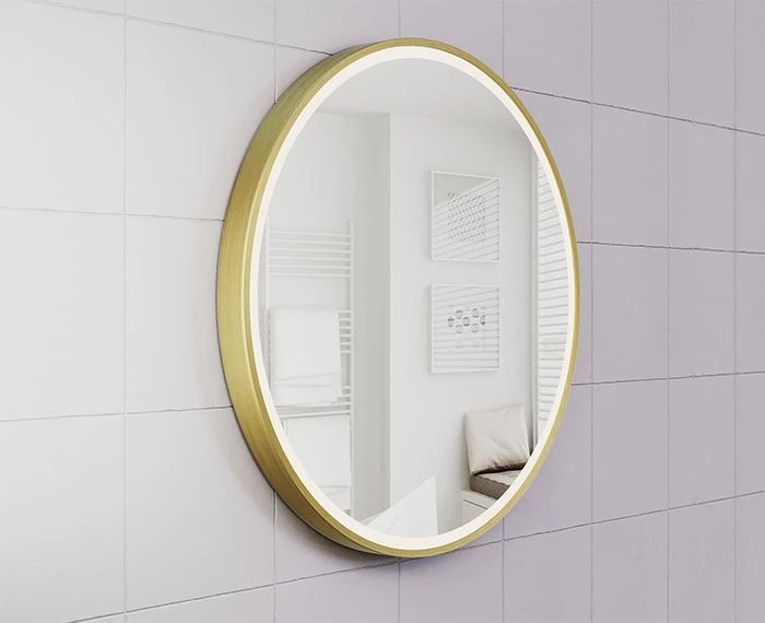 A round custom lighted mirror with a golden frame hanging on a bathroom wall in Brisbane.