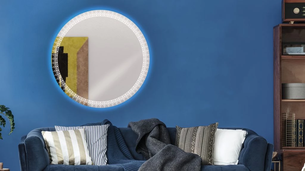 Blue couch and round mirror with lights in a cozy living room in Perth.