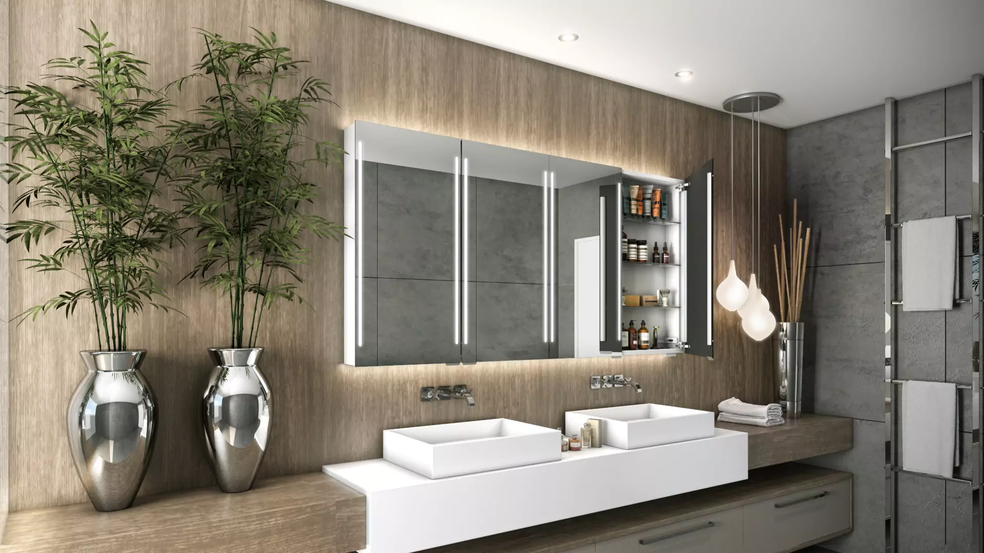 Cabinet-lighted mirror wall-mounted above the white basin with two bamboo trees in a silver planter.