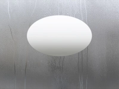 Moist mirror glass with an oval-shaped defogger in its center.