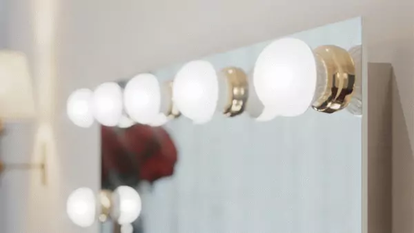 Close up of a hollywood lighted mirror with bulb lights mounted in gold rings in Canberra.