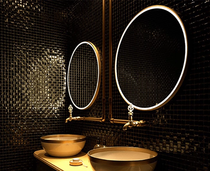 Two sinks and a circular Grand Mirrors Allure mirrors in a stylish bathroom in Brisbane.