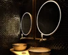 A preview of two sinks and a circular Grand Mirrors Allure mirrors in a stylish Victoria bathroom.