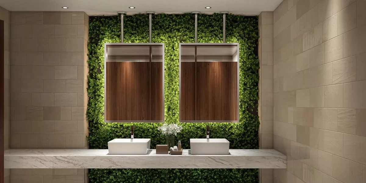 Stainless steel ceiling mounted mirrors with green grass wall and two sinks in Melbourne.