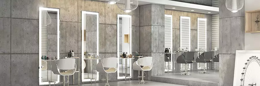 Salon with a full-length lighted mirror and comfortable chairs in a functional place.