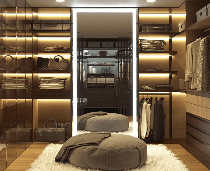 A walk-in closet, showcasing fashionable clothes and a Grand Mirrors Lux mirror in Tasmania.