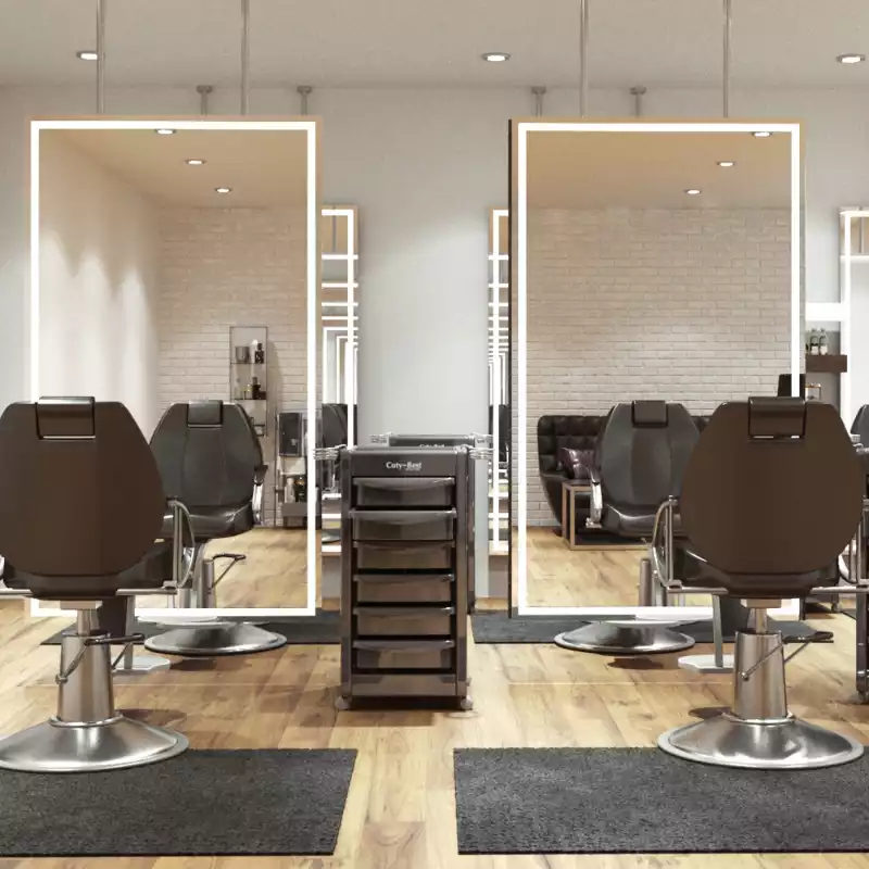 Ceiling-mounted full-length lit mirrors with black chairs and a salon trolley cart in a parlor.