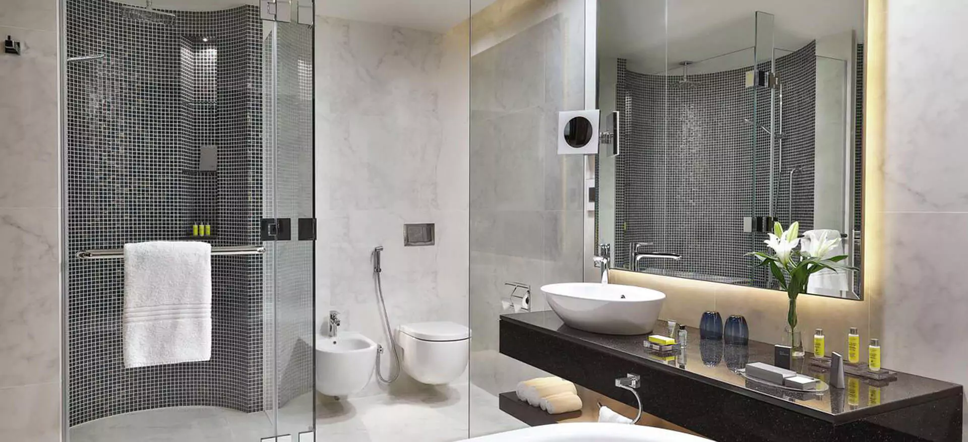 Contemporary bathroom design showcasing a glass shower and premium backlit mirror in Adelaide.