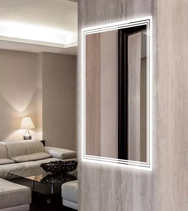 A large mirror with lights mounted on a wall in a room, reflecting the surroundings in Hobart.