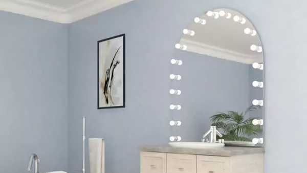 Thumbnail of an arch shaped hollywood mirror mounted on a light blue wall in a modern bathroom in Hobart.