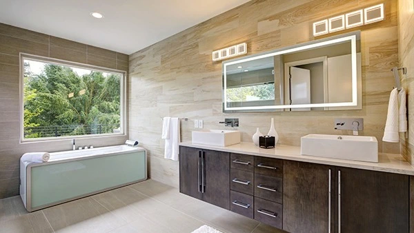 Icon of modern, minimalist bathroom featuring a spacious lighted mirror on a sink in Hobart.