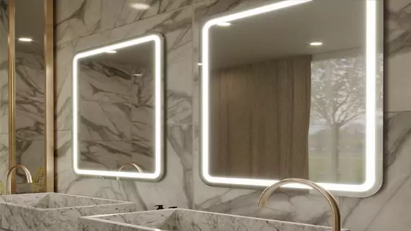 Two sinks and illuminated mirrors in a golden-themed bathroom in Darwin.