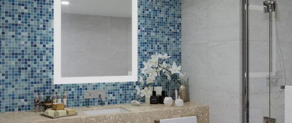 LED mirror for bathroom mounted on glass mosaic tiles above a recessed marble sink in Sydney. 