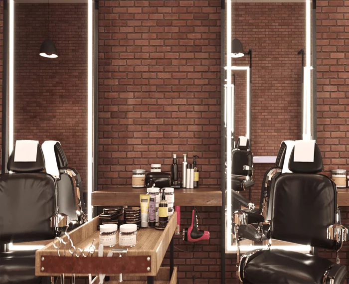 Two beauty salon mirrors are divided by a salon cart with beauty essentials in Lismore.