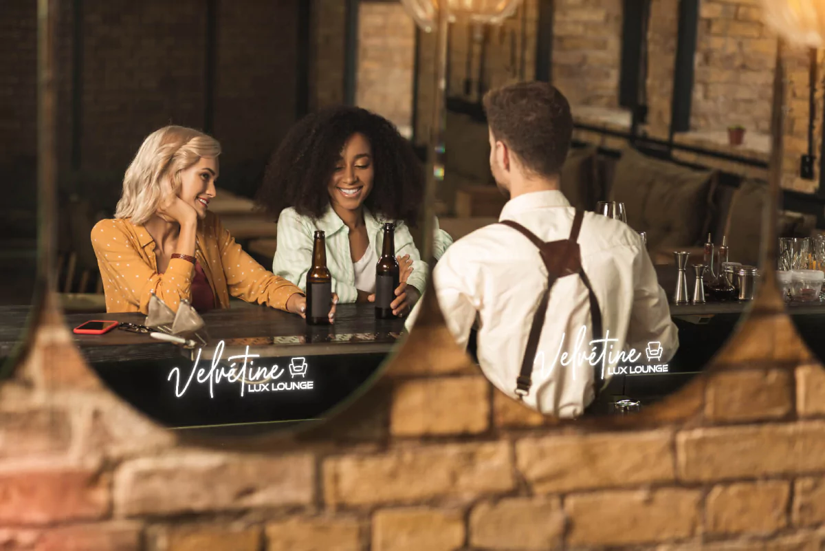 Reflection of three people that are sitting at a bar while talking with each other in Newcastle.