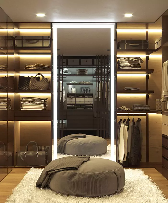 A modern walk-in closet with a mirror, showcasing organized shelves and clothes in Perth.