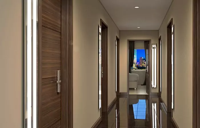 Hallway with LED lights beside the wooden doors and cream colored wall in Newcastle.