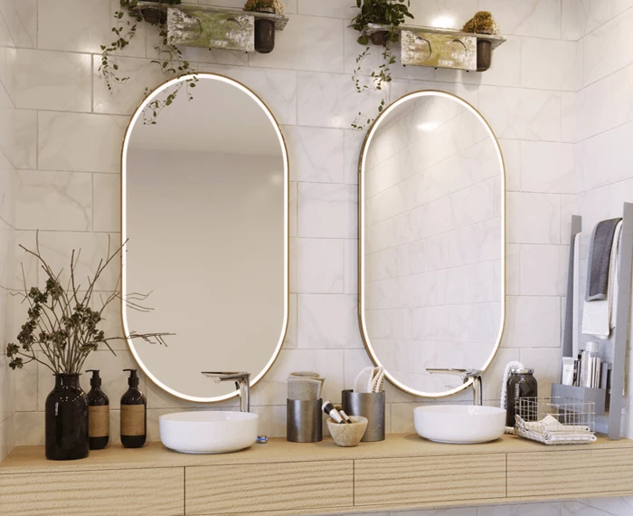 Contemporary bathroom in Darwin with two sinks and oval custom lighted mirrors.