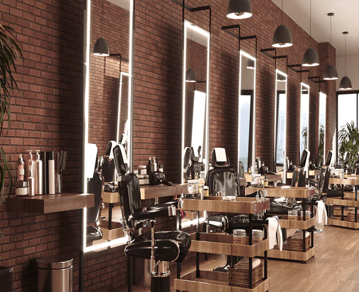 Chairs and trolleys placed in front of each salon LED mirror mounted on a brick wall in Wellington.