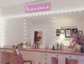 Thumbnail of a glamorous vanity with a lighted Grand Mirrors Hollywood and pink neon sign in Perth.