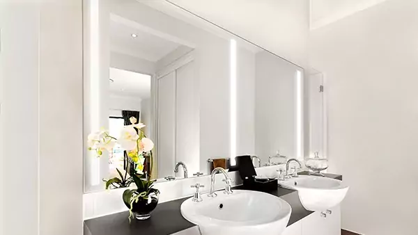 Preview of a white spacious bathroom with two sinks and a customized lighted mirror in Tasmania.