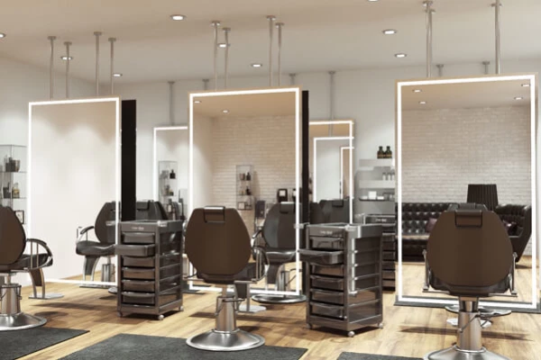 Salon LED mirror with three chairs in front and two salon trolleys in between mirrors in Hobart.