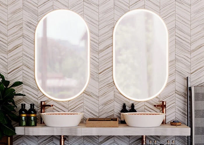 Elegant bathroom with oval aluminium framed mirrors above dual sinks in Queensland.