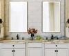 A preview of bathroom with two sinks and a rectangular custom lighted mirror in Perth.