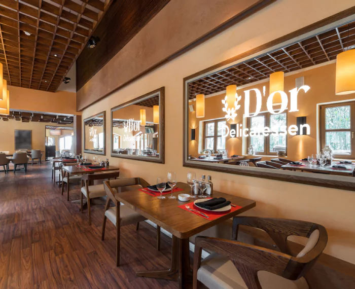 Restaurant ambiance with wooden floors, and mirrors with distinctive LED light logos in Tasmania.