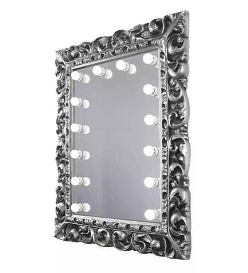 Silver framed vintage mirror from Sydney enhanced by shimmering lights provides a radiant ambiance.