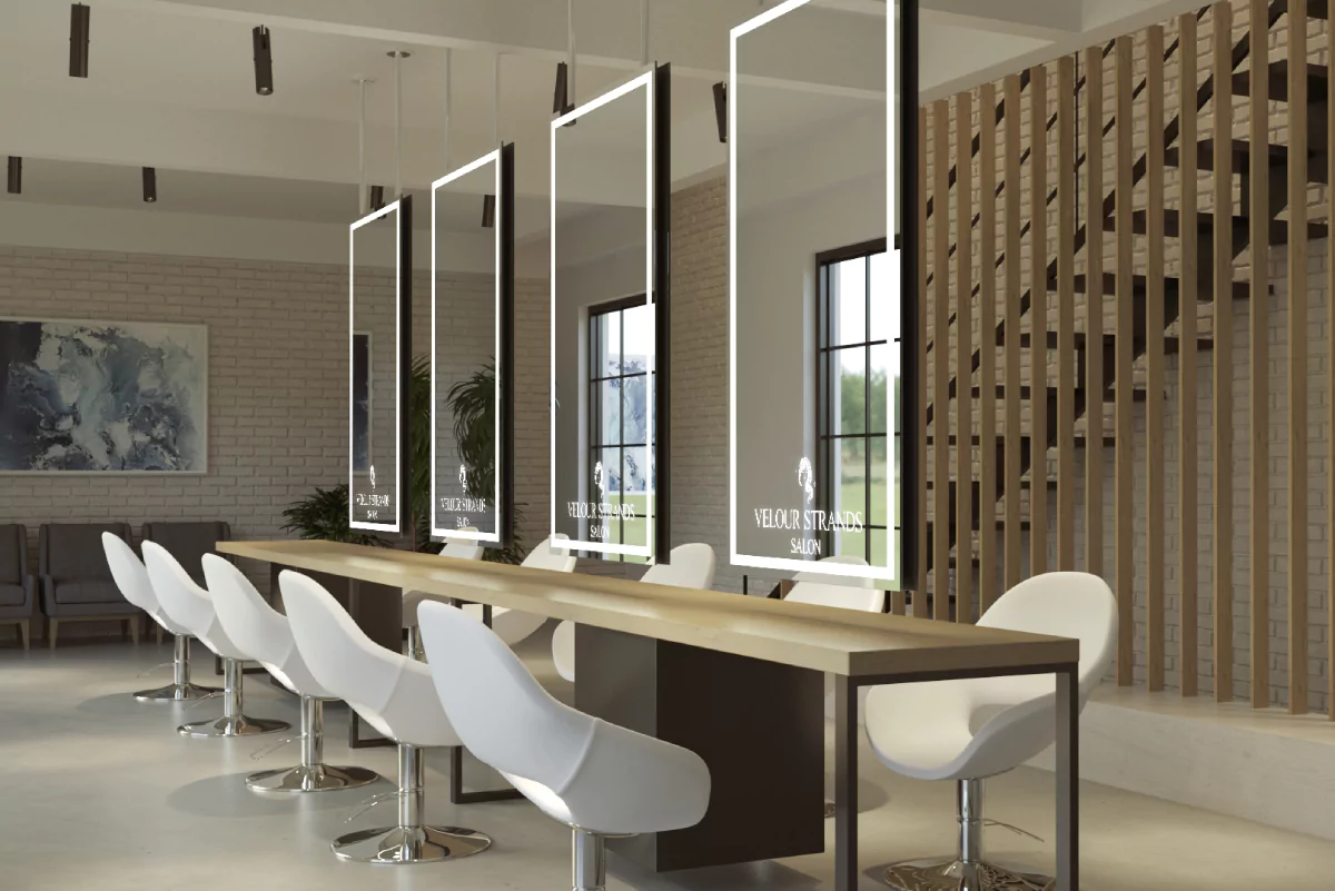 Sleek salon featuring a lengthy table, chairs, and mirrors with glowing logo in Newcastle.