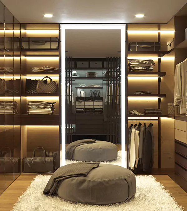 A snippet of walk in closet with a mirror, showcasing organized shelves and clothes in Wellington.