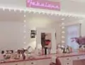 Thumbnail of white room with pink marble vanity desk below salon mirror with lights in Sydney.