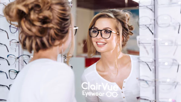 Thumbnail of a woman checking out glasses in a mirror featuring illuminated logo in Newcastle.