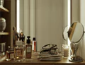 Thumbnail of a table with magazines and makeups reflected in a vanity lighted mirror in Brisbane.