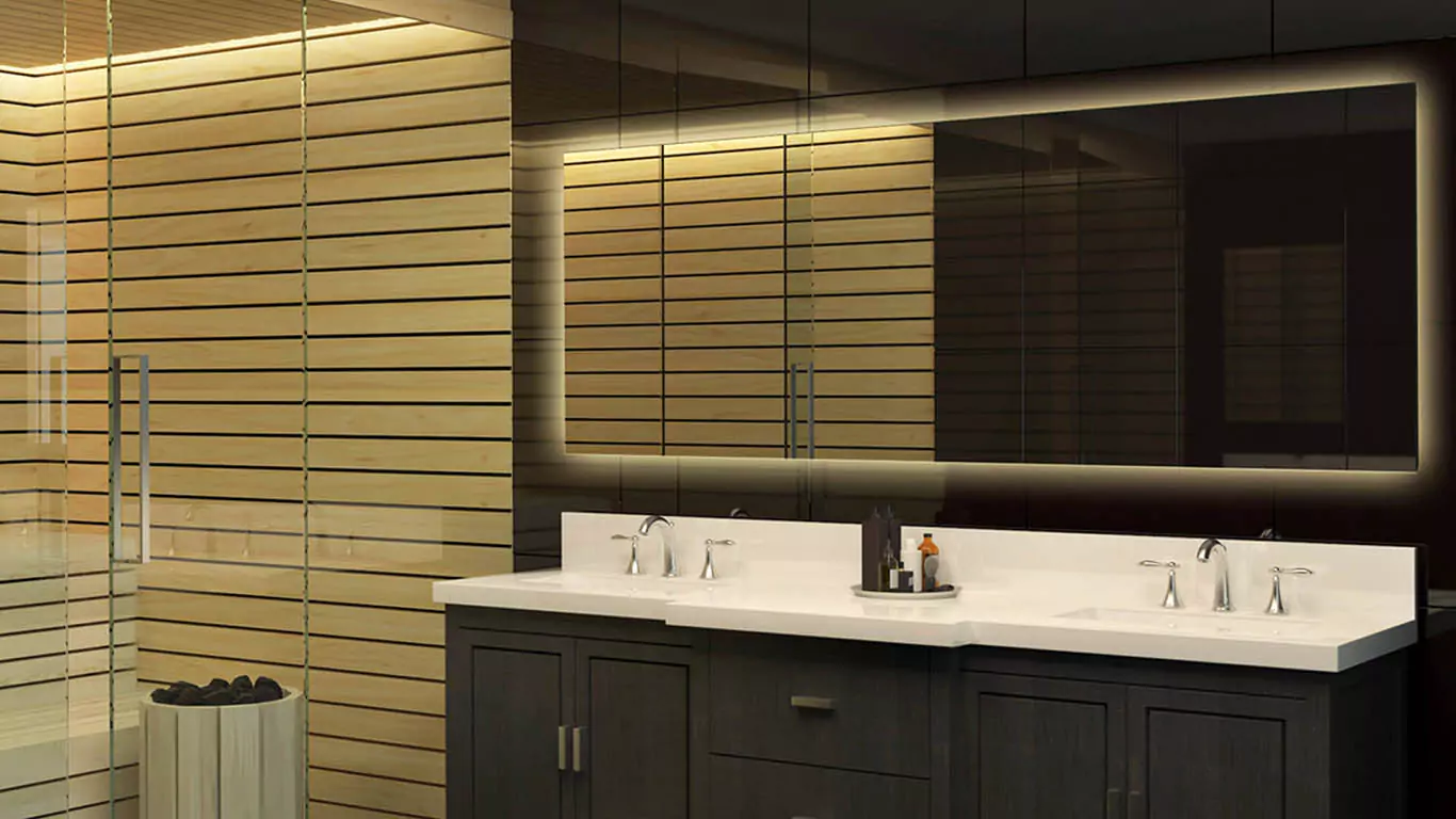 A dark bathroom with a lighted vanity mirror and a sink in Wellington.