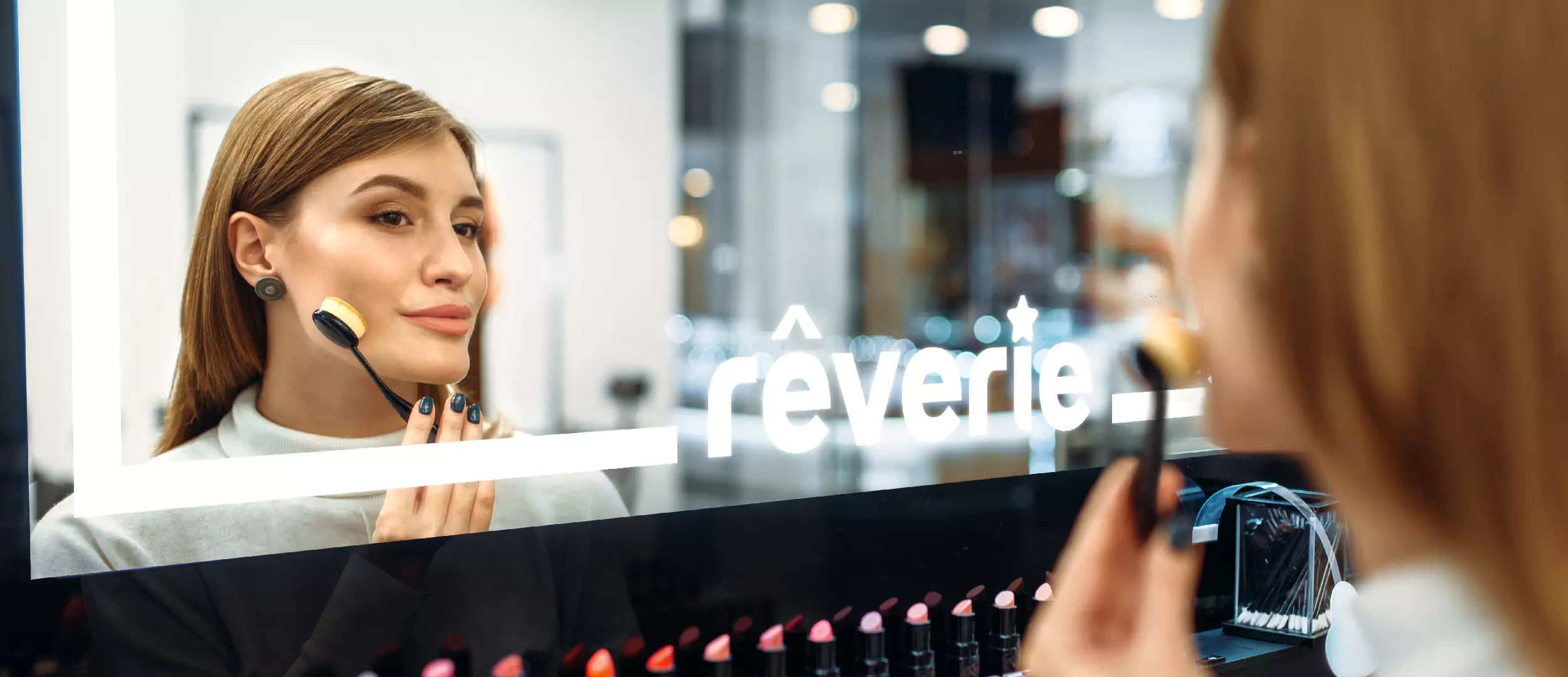 Woman doing makeup in front of the mirror with custom LED light logo in Queensland.