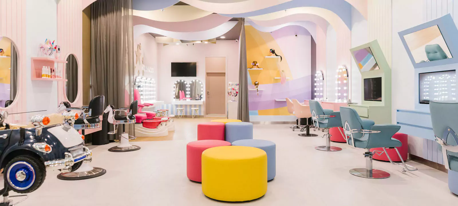 Colorful salon with Grand Mirrors hollywood, playful decor, and child friendly seating in Victoria.