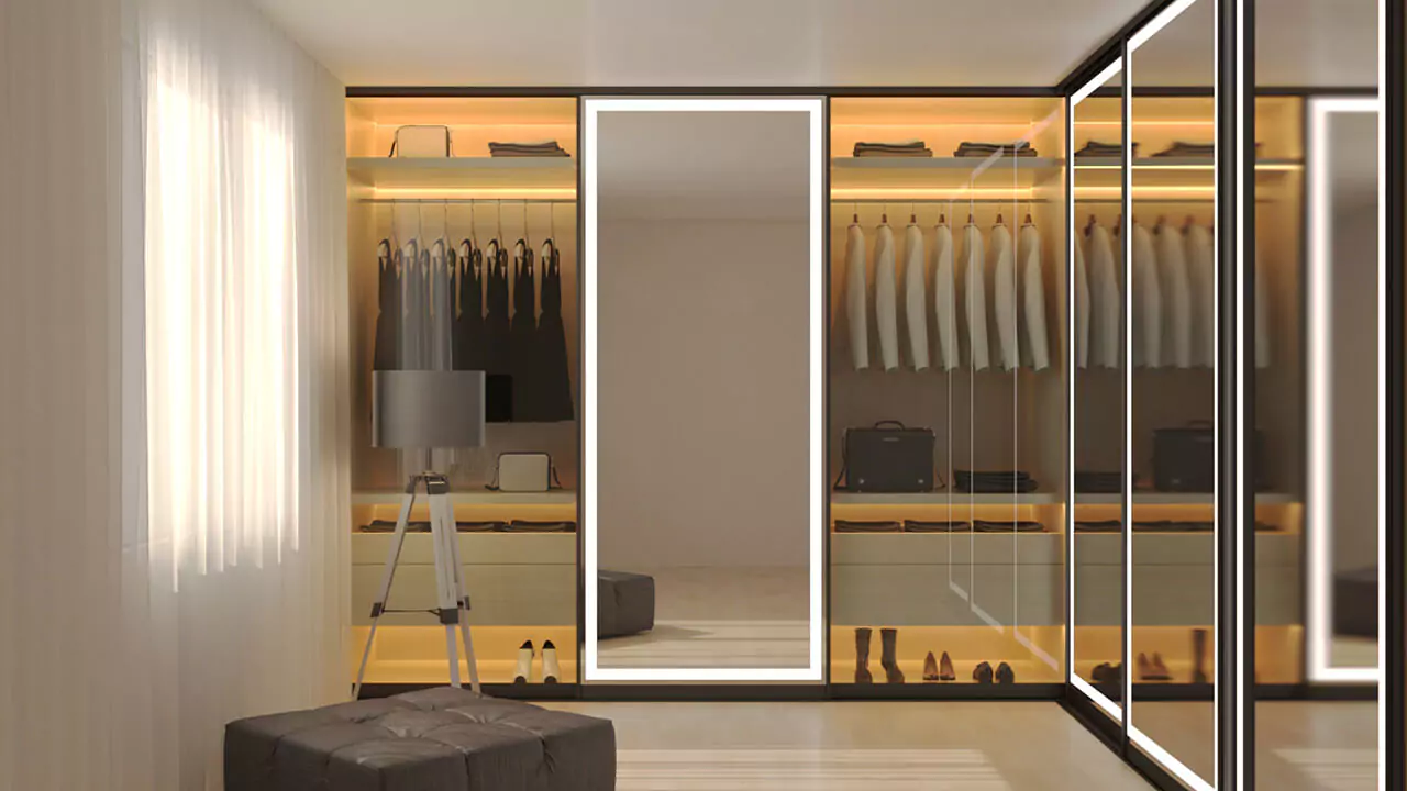 A modern walk-in closet with a light framed mirror and neatly arranged clothes in Hobart.