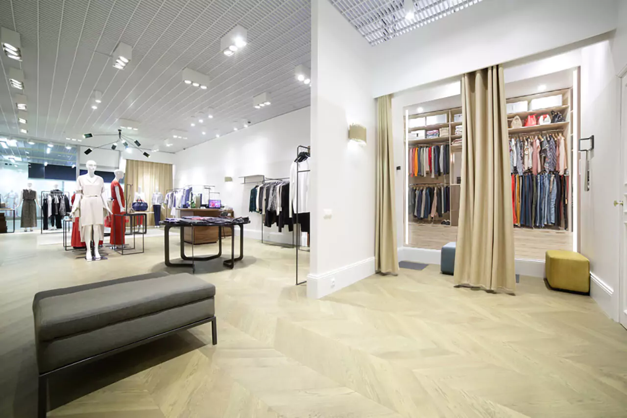 Spacious clothing store with a large closet, benches and well-lit mirrors in Adelaide.