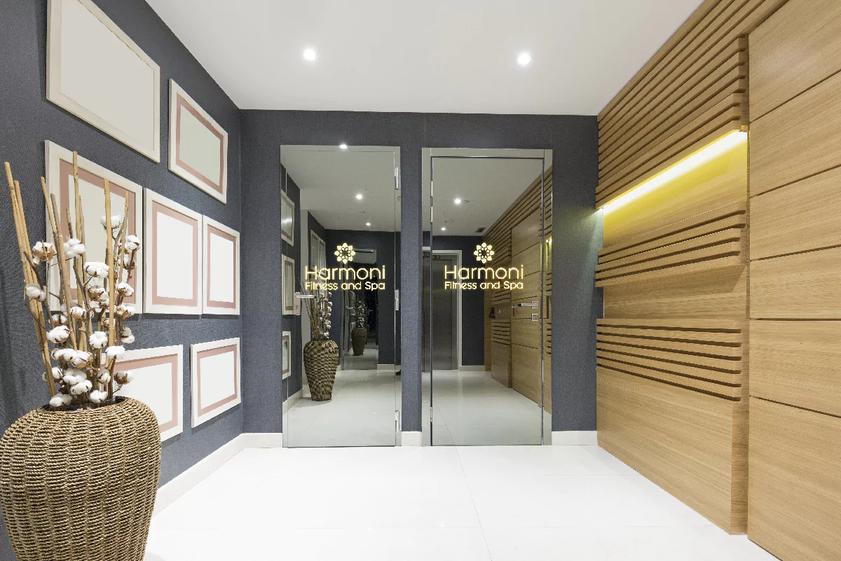 A well lit spa adorned with a vase and a mirror displaying an illuminated logo in Lismore.