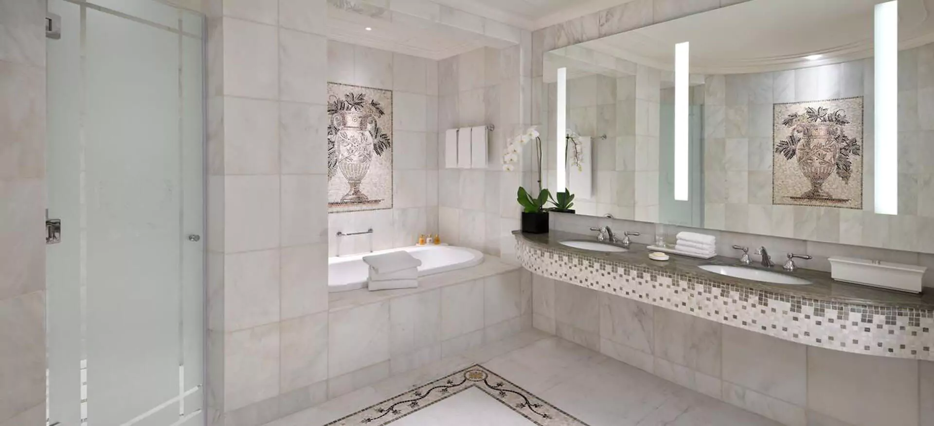 A spacious bathroom in Wellington featuring a double sink mirror and a sleek sink.