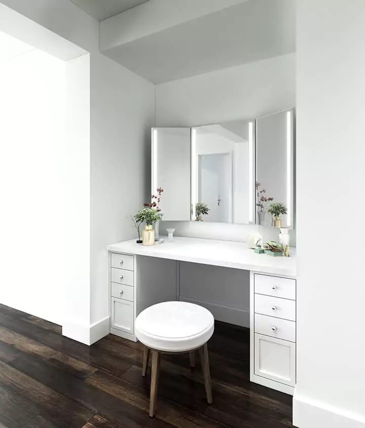 A white vanity with trifold mirrors and a stool in Tasmania, perfect for getting ready in style.