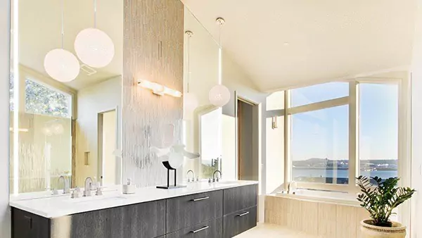 Compact of expansive bathroom showcasing a large window, and a lighted mirror in Queensland.